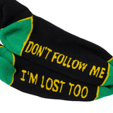 Black socks with green accents and humorous text on a white background