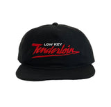 A black flat-brim snapback cap with 'LOW KEY Tenderloin' embroidered on the front, featuring white and red lettering.