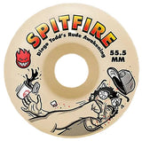 A single Spitfire skateboard wheel with a cream-colored urethane body, featuring the Spitfire brand logo, the text 'Diego Todd's Rude Awakening 55.5 MM', and a cartoon illustration of  geDtting rocked.