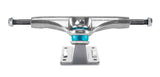 Thunder skateboard truck with a silver metallic chrome finish, featuring a bright blue polyurethane bushing in the center,.