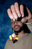 Hand holds Walter Keychain by Quasi Skateboards, featuring a cartoon character giving the middle finger.