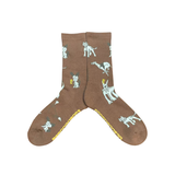 Psockadelic Dog World Psocks: brown socks with various white dog illustrations, yellow text on the soles.