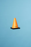 Orange Quasi Skateboards Stress Cone with black base, on a light blue background