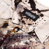 Read My Bones Button Up shirt by Deathwish Skateboards, close-up of collar and button with paint splatter design.