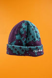 Quasi Skateboards Dither Beanie in Eggplant, purple and teal knit beanie with dotted pattern and white embroidered logo.